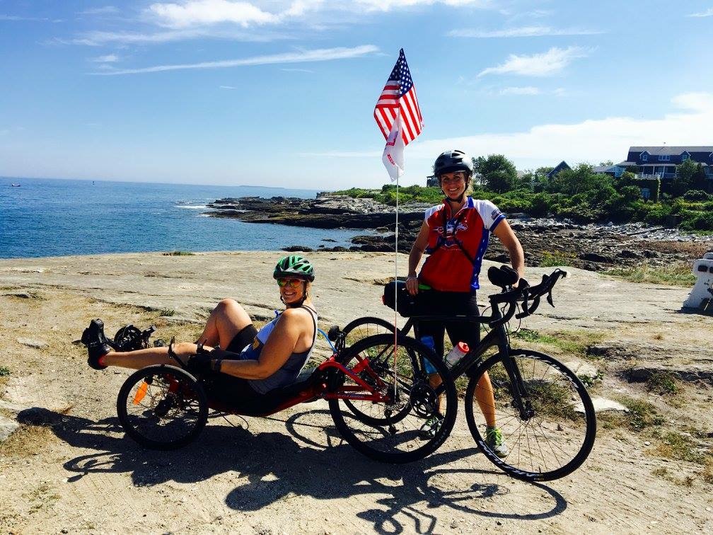 Mary Torczon (L) and Jennifer Weatherford on the shores of the Atlantic Ocean during the Maine Lighthouse Ride in Portland, Maine.